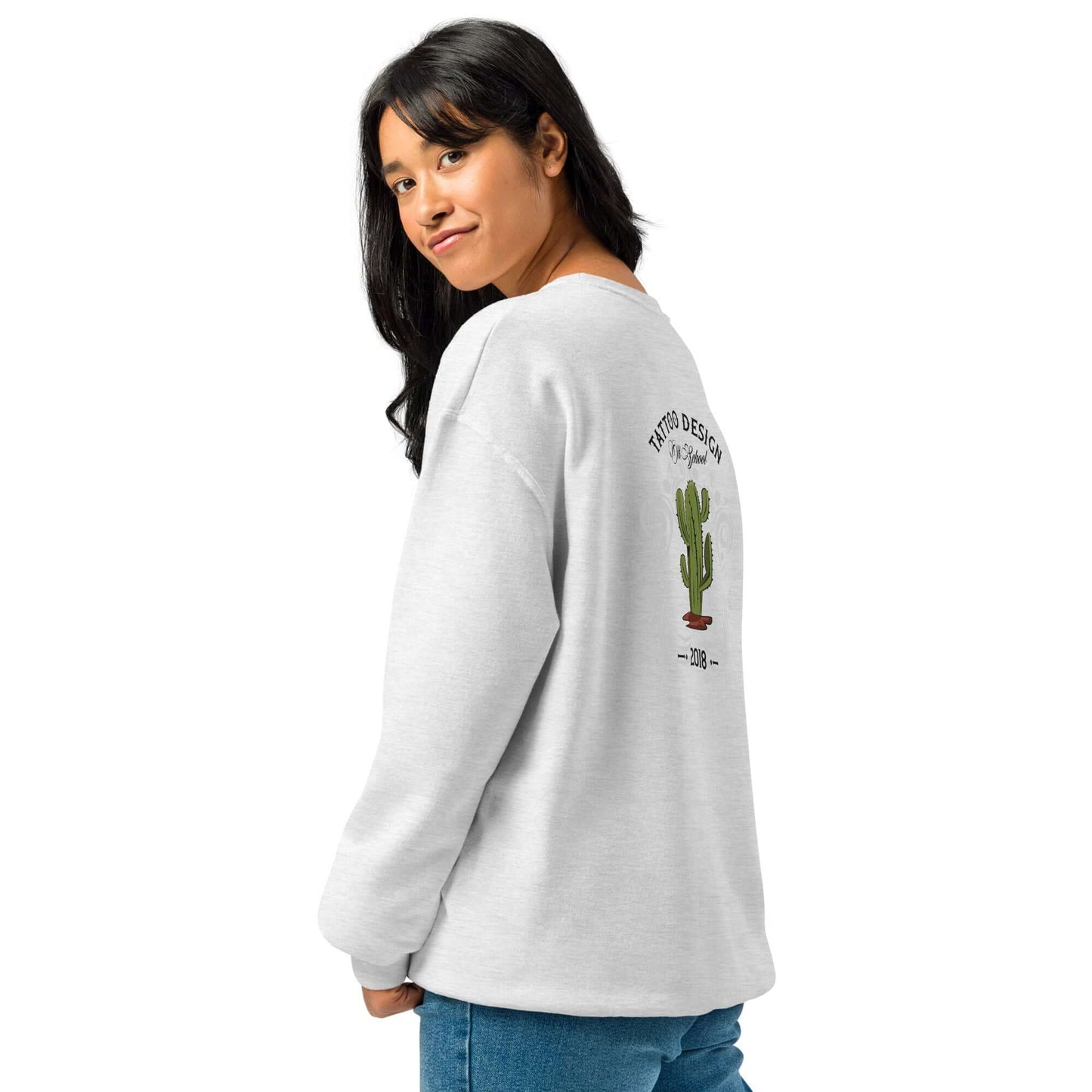 Woman wearing a cozy crew neck sweatshirt with a cactus design on the back, featuring a relaxed fit and pill-resistant fleece.